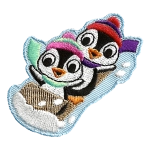 Two penguins raise their flippers in the air as they speed along on a wooden toboggan. The penguins are wearing toques and scarves.