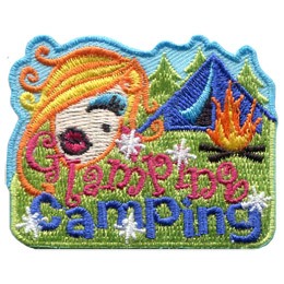 The head of a young woman with perfect hair and a made-up face floats beside a tent and a campfire. Underneath, the words 'Glamping Camping' are embroidered amidst sparkles.