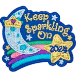 A crescent moon on top of a shooting star that reads Keep Sparkling On, 2024.