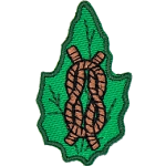 A knot tied from rope on a green leaf.