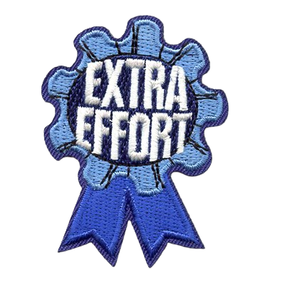 A patch in the shape of a blue ribbon with the words Extra Effort.