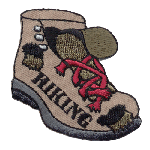 A hiking boot with several holes and red laces. Hiking is stitched on the side.