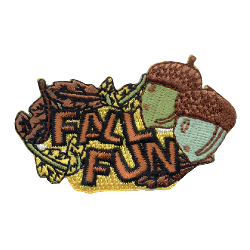 The words Fall Fun is stitched in a pile of leaves. Two acorns sit to the top right. 