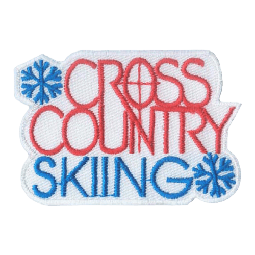 The words Cross Country are in orange and Skiing is in blue. Two blue snowflakes frame the start and end of the sentence.
