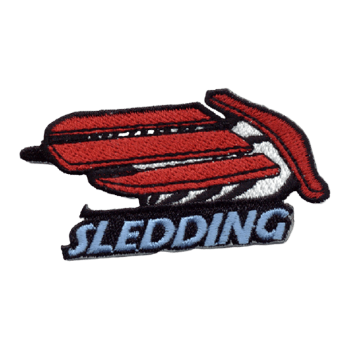 A red runner sled with the word Sledding in light blue thread underneath.
