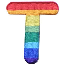 This patch is the letter T in bold font. It is coloured by descending rainbow stripes.