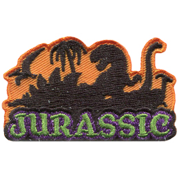 The word Jurassic sits at the bottom of this crest with the shadows of dinosaurs looming in the background. The shadows from left to right are: a pterodactyl, a stegosaurus, a tyrannosaurus rex, a apatosaurus, and a parasaurolophus.