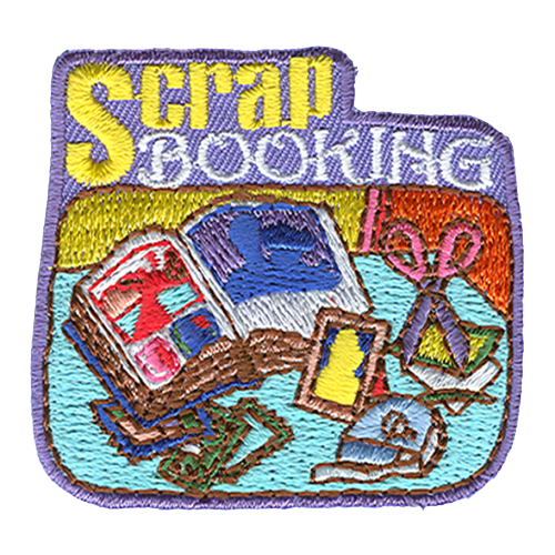 The word Scrapbooking above an open book, scissors, tape and photos.