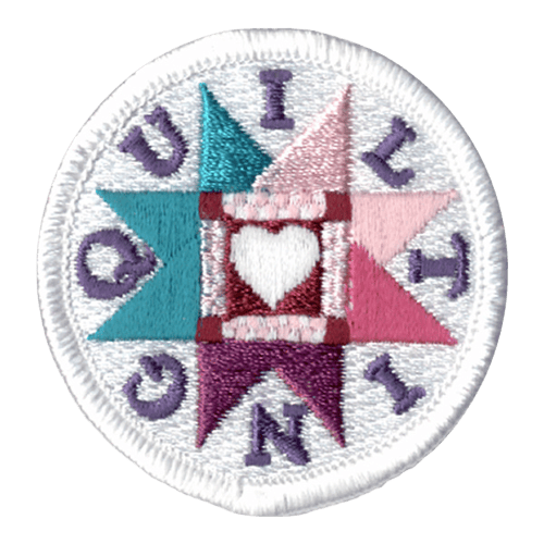 This round, white, merrow bordered patch has a white heart inside a square frame and surrounded by a starburst pattern. The word ''Quilting'' is formed with each individual letter placed inside the recess of the starburst pattern.