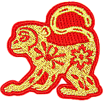 A gold monkey with a red outline and floral details on its body.