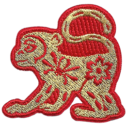 A gold monkey with a red outline and floral details on its body.