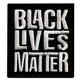 A black rectangle has the words Black Lives Matter embroidered in grey thread. Each word is stacked on top of the next.