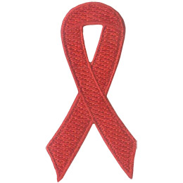 A red ribbon is curled on itself to form a simple loop.