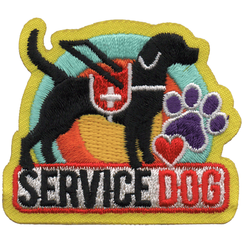 A black lab stands proud in their vest overtop of the words Service Dog.