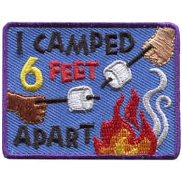 Two hands holding marshmallows skewered on sticks reach towards a campfire from opposite ends of the crest. The text reads 'I Camped 6 Feet Apart'.
