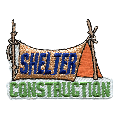 A rope is tied near the top of two vertical branches that form the poles for a tent. A blanket is draped over the rope to create the tent itself. The word ''Shelter'' is written on the makeshift tent and ''Construction'' is embroidered in green underneath.