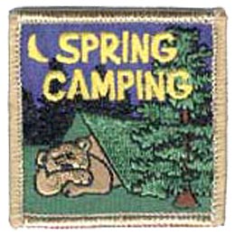 A bear is sound asleep in a green tent, deep in an evergreen forest. A crescent moon lights up the night sky. The words ''Spring Camping'' are embroidered in yellow at the top of this square shaped patch.