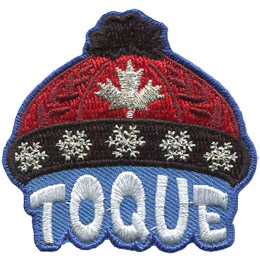 This red knit cap, called a 'Toque' in Canada, has a black pom-pom on the crown and a black brim with silver metallic snowflakes. A Canadian maple leaf is displayed on the center of the red hat. The cap is sitting on the word 'Toque'.
