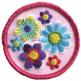 Blue, pink, purple and yellow flowers are clustered together on a pink background.