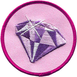 This circular badge has an image of a glittering amethyst on a pink background.