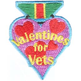 A heart-shaped badge with the words Valentines For Vets in the center.