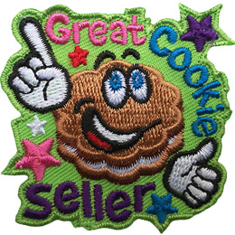 A flower-shaped cookie with frosting in the middle and big, cartoon eyes grins and points to the words Great Cookie Seller.