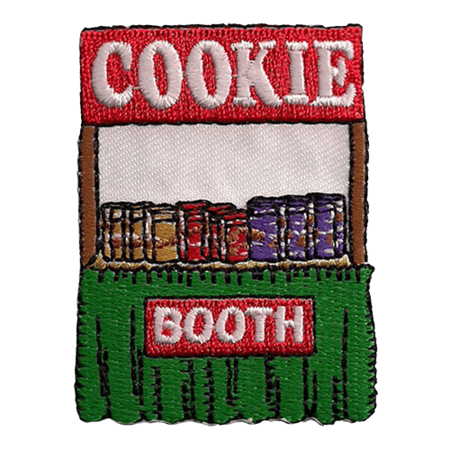 A booth with boxes of cookies on it. The sign says Cookie, and a smaller sign says, Booth.