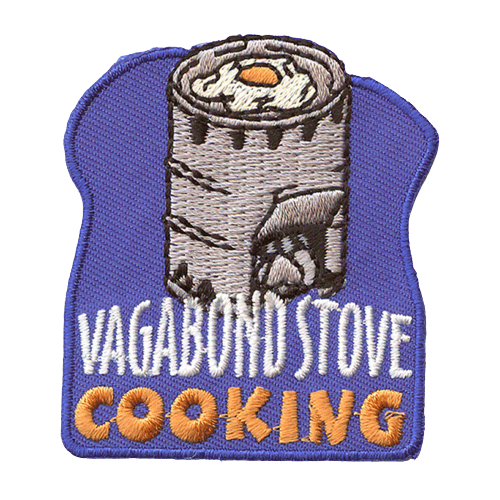 A vagabond stove cooks an egg. The words Vagabond Stove Cooking are stitched below.
