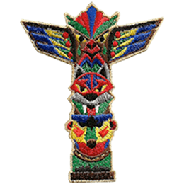 A totem pole showcases a monkey at the bottom, a wolf in the middle, and an eagle at the top. The totem pole has been painted in vibrant colours.