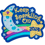 A crescent moon on top of a shooting star that reads Keep Sparkling On, 2024.
