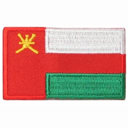 The national flag of Oman consists of three stripes (white, green and red) with a red bar on the left that contains the national emblem of Oman (a dagger and two swords).