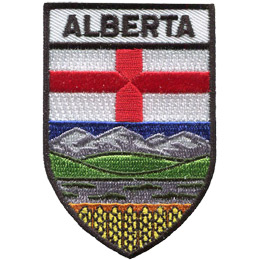 This shield shaped badge is broken into three horizontal sections. The top most bar has the name 'Alberta'. The second section has a white background with a red cross splitting the background into four even quarters. The last section has blue sky, mountains, green hills, and a field of golden wheat at the bottom.