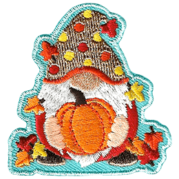 A gnome holds a ripe pumpkin. The gnome is covered in leaves and wears a red and yellow polka-dotted hat.