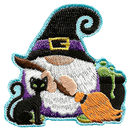 A gnome dressed as a witch holds a broom next to a black cat and a bubbling cauldron.