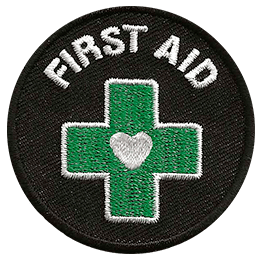 This round First Aid patch displays a green cross with a heart in the center.