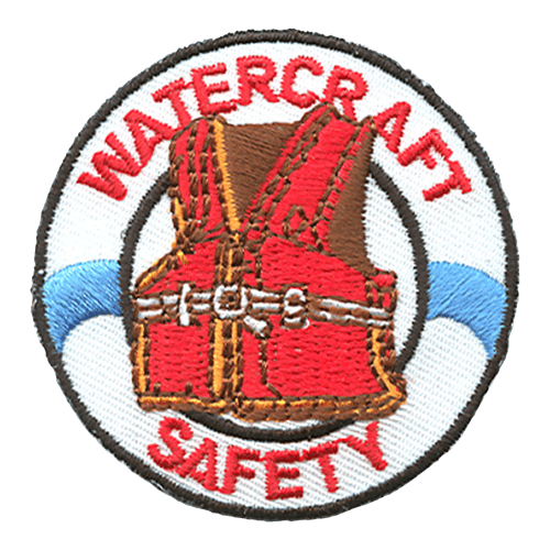 A red lifejacket sits inside a white life preserver. The words Watercraft Safety are stitched around the inside of the preserver.