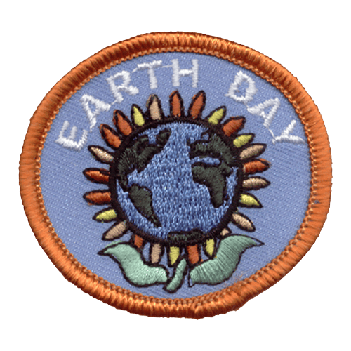 This round patch displays a sunflower where the head is Earth itself. The words Earth Day arch over the flower.
