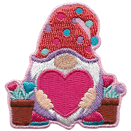 A gnome holds a big heart, and potted heart flowers stand to either side of him.