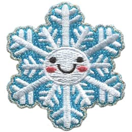 A 12-pointed snowflake has dots for eyes and a big U-shaped smile.