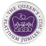 Circle badge with the Queen’s crown on a backdrop of royal purple with a white ring.
