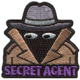 A person wearing a wide-brimmed hat and a brown trenchcoat. The words Secret Agent are across the bottom.