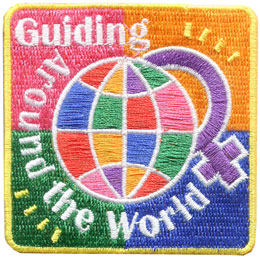 A multicoloured globe on four coloured squares. The female symbol is behind the globe. The words around the globe are Guiding Around The World.