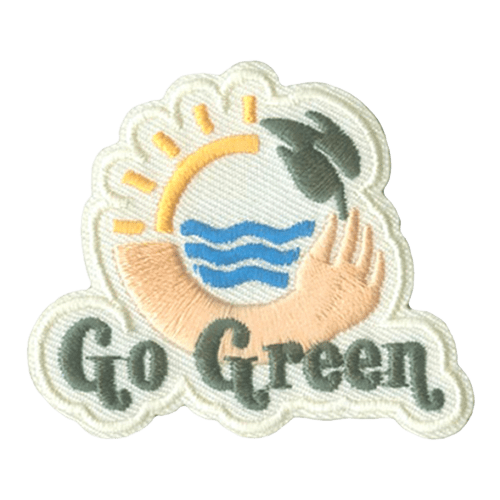 A circle is made up of four different parts: a 1/4 of the sun, an arm holding a leaf, and water in the center. Go Green is stitched below in green thread.