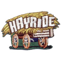 An old wooden wagon hauls a huge load of golden hay with the word ''Hayride'' embroidered in all capital letters.