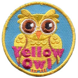 A yellow coloured owl is displayed with its wings closed at its side.