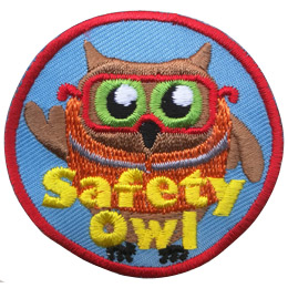An owl wears an orange safety vest and safety glasses. The text, Safety Owl is embroidered near the bottom of this circular patch.