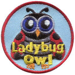 This owl is disguised as a ladybug. It has big blue eyes, antennae, and black-spotted red wings. The words Ladybug Owl are across the bottom.
