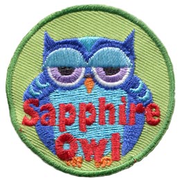 A fat blue owl with half-lidded eyes. The words Sapphire Owl are across the bottom.