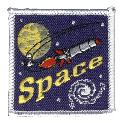 A red and silver rocket soars through space. The word Space is stitched below it. A planet and a galaxy are in the background.