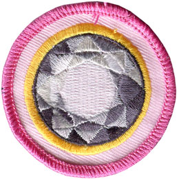 The top of a diamond surrounded by a yellow ring on a pink background.